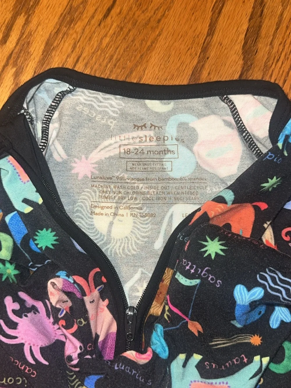 Little Sleepies Black Zodiac Print Footie with Colorful Accents
